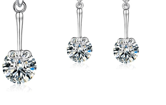 Silver dangly earrings and necklace with bow detail and cubic zirconia gift set