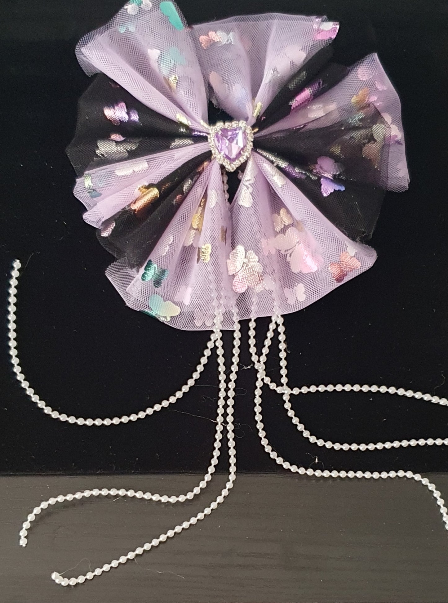 Purple and black large ribbon bow with dangly pearl beads and purple gem heart centre