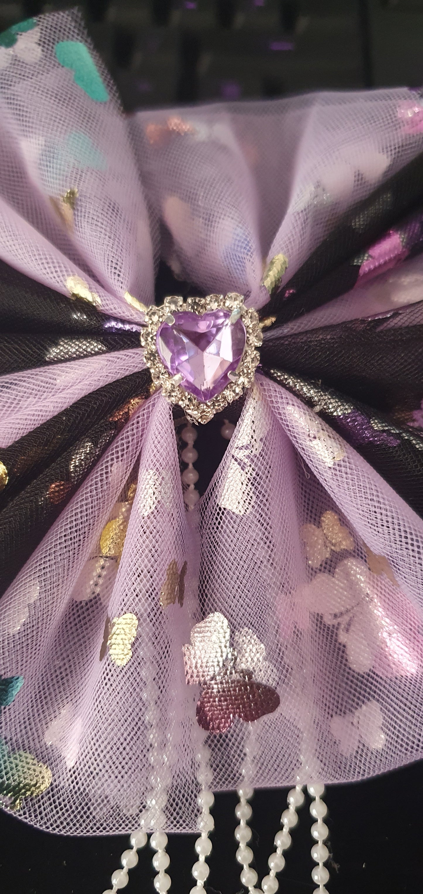 Purple and black large ribbon bow with dangly pearl beads and purple gem heart centre