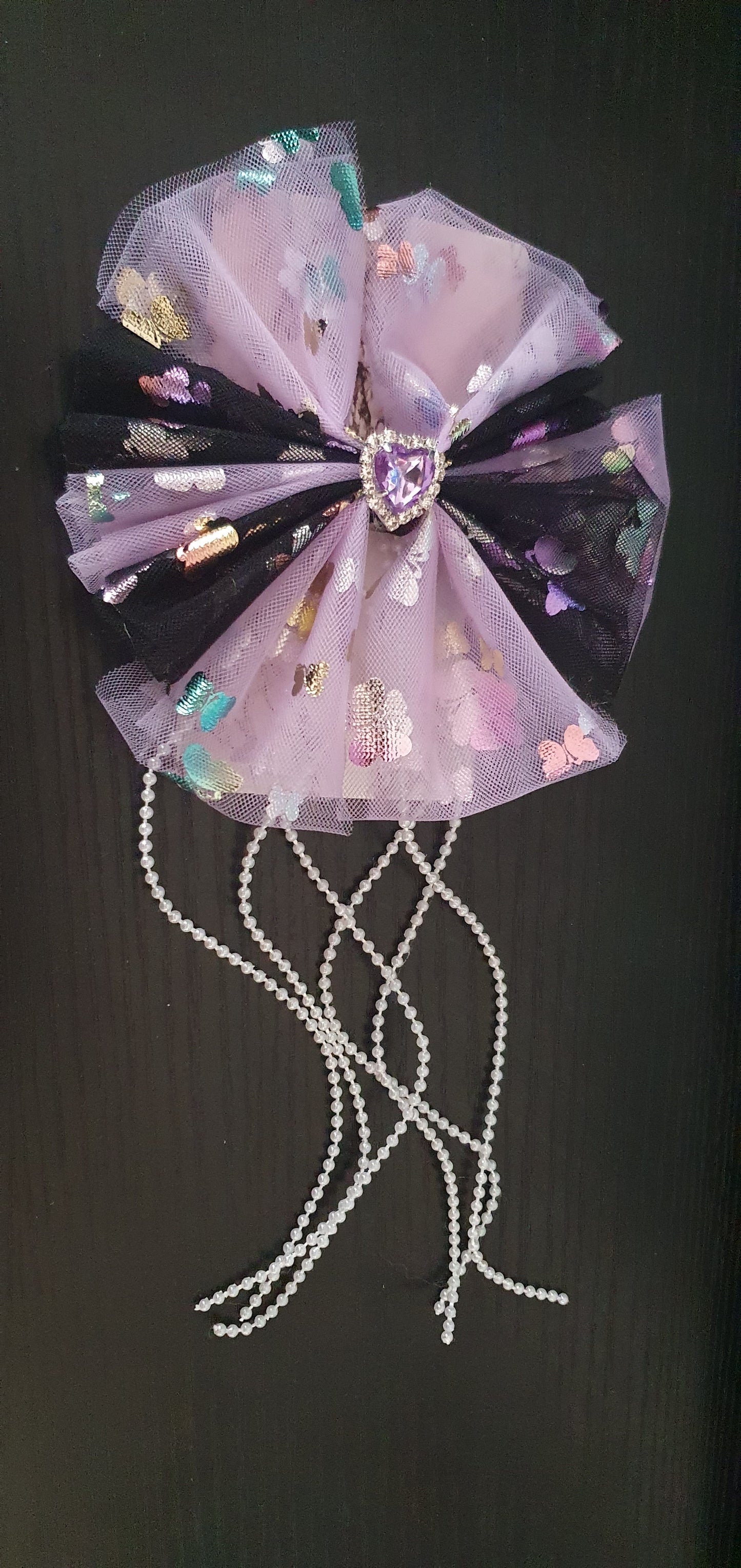 Purple and black large ribbon bow with dangly pearl beads and purple gem heart centre