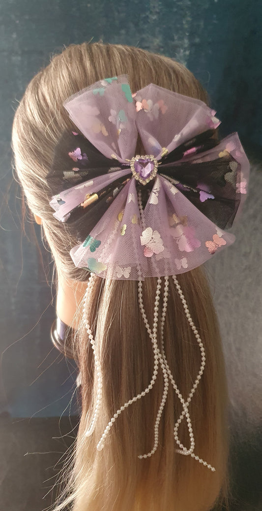 Purple and black large ribbon bow with dangly pearl beads and purple gem heart centre