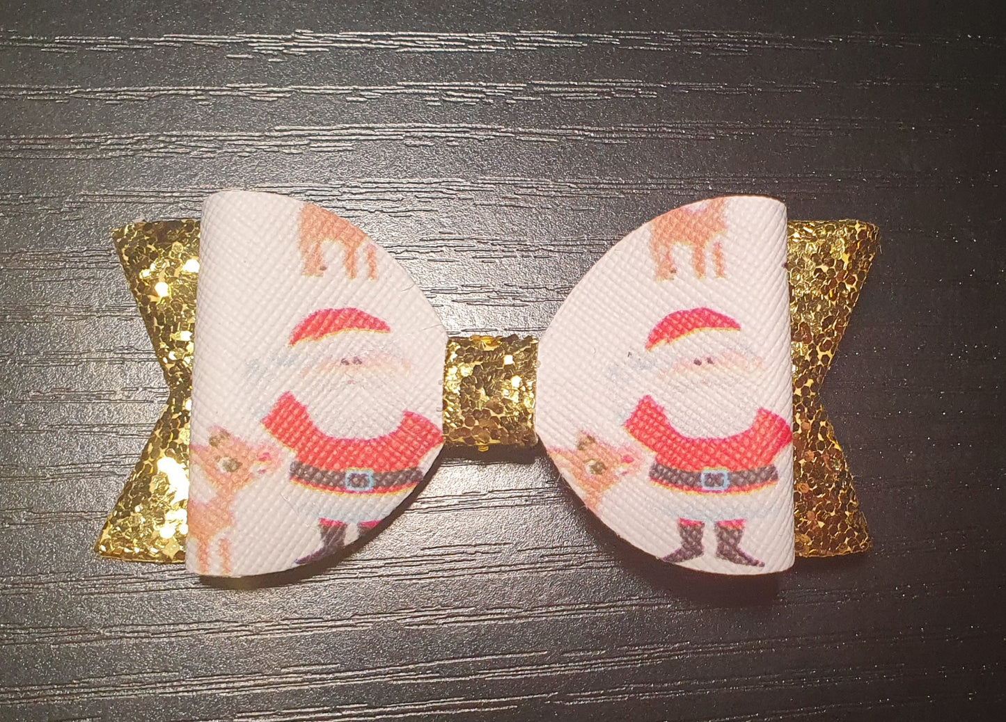 Father Christmas and reindeer and glittery gold hair bow