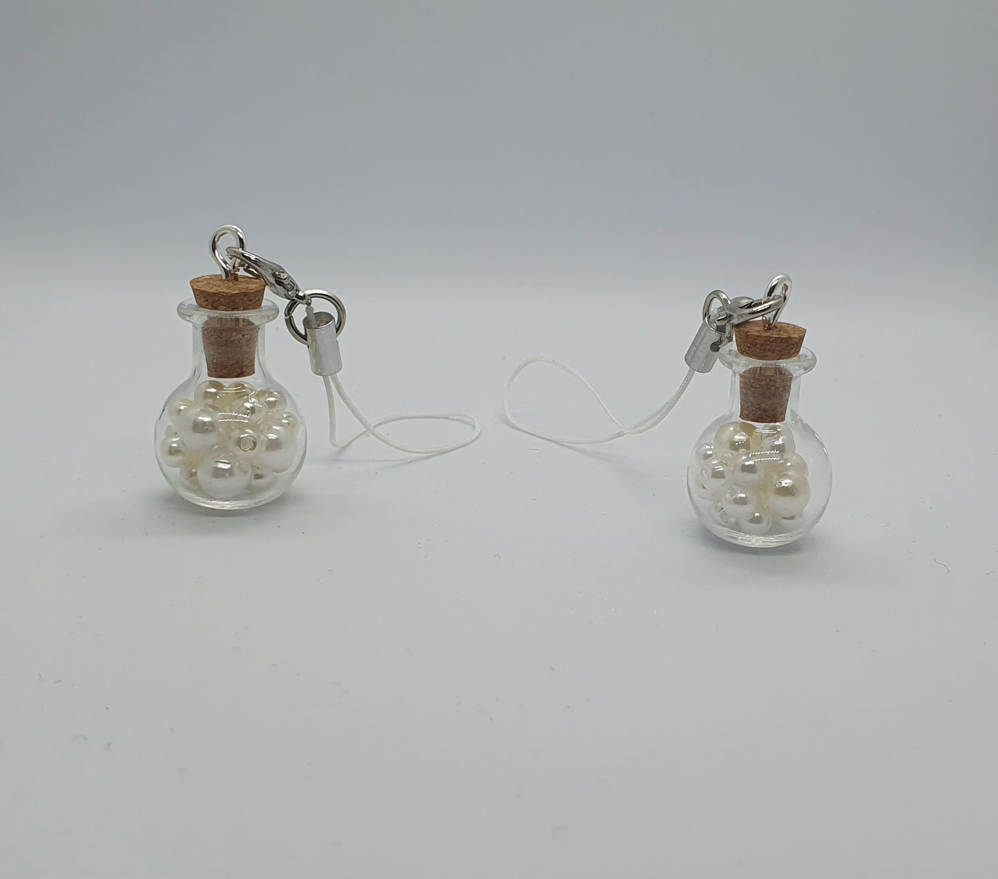 Glass potion bottle with faux pearl beads and rose keepsake charm