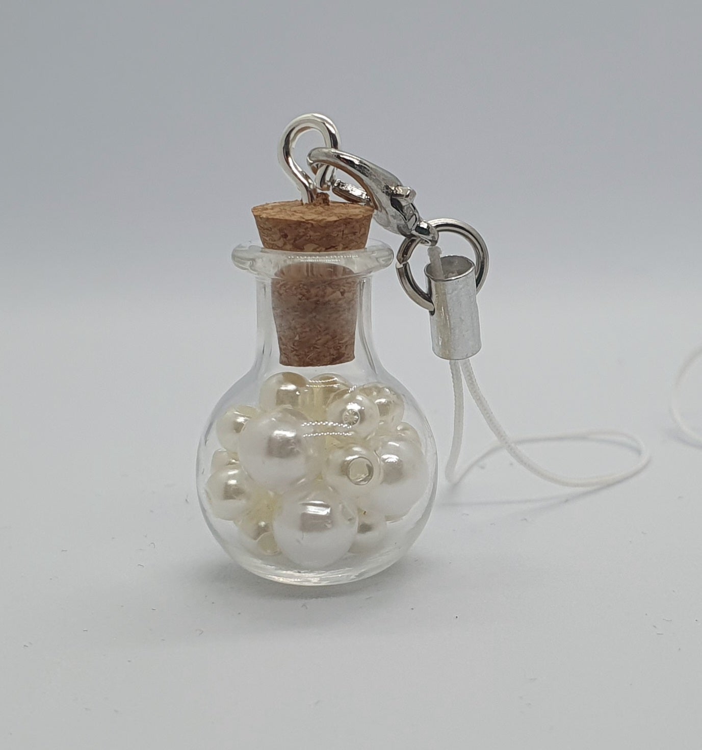 Glass potion bottle with faux pearl beads and rose keepsake charm