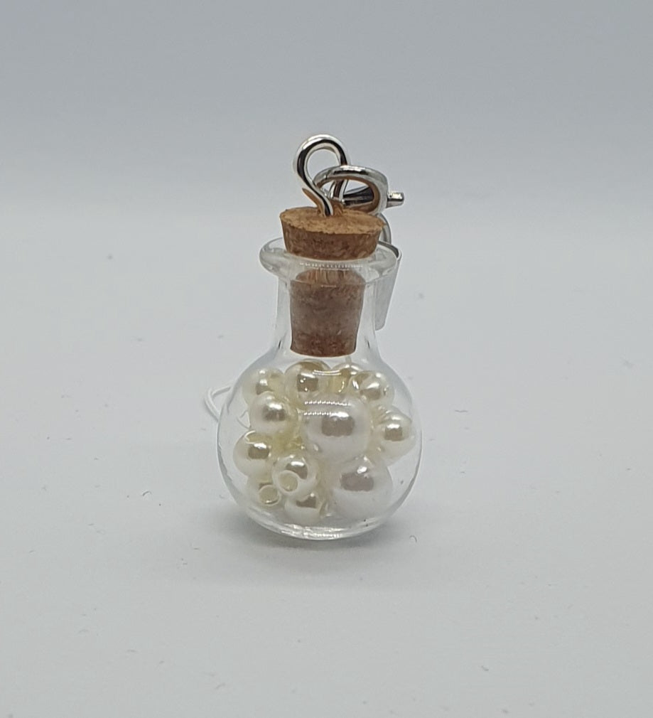 Glass potion bottle with faux pearl beads and rose keepsake charm