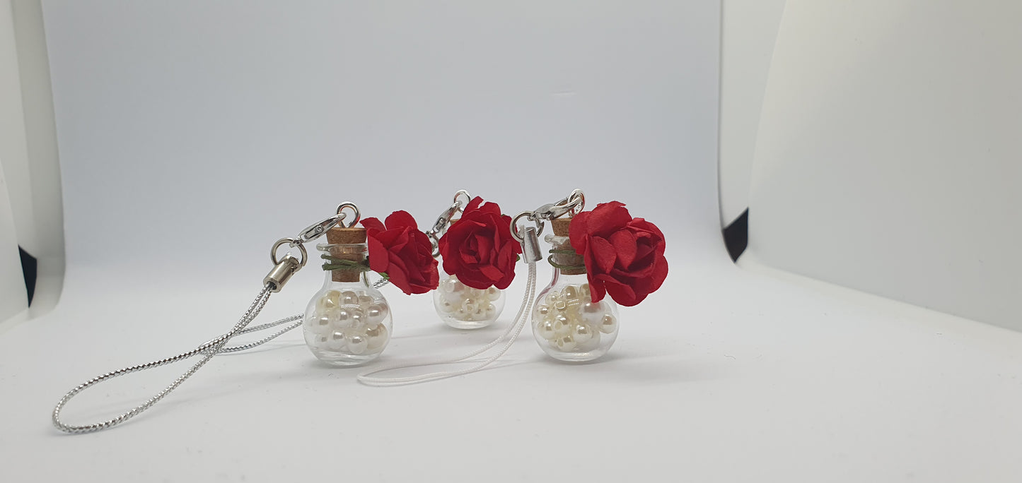 Glass potion bottle with faux pearl beads and rose keepsake charm