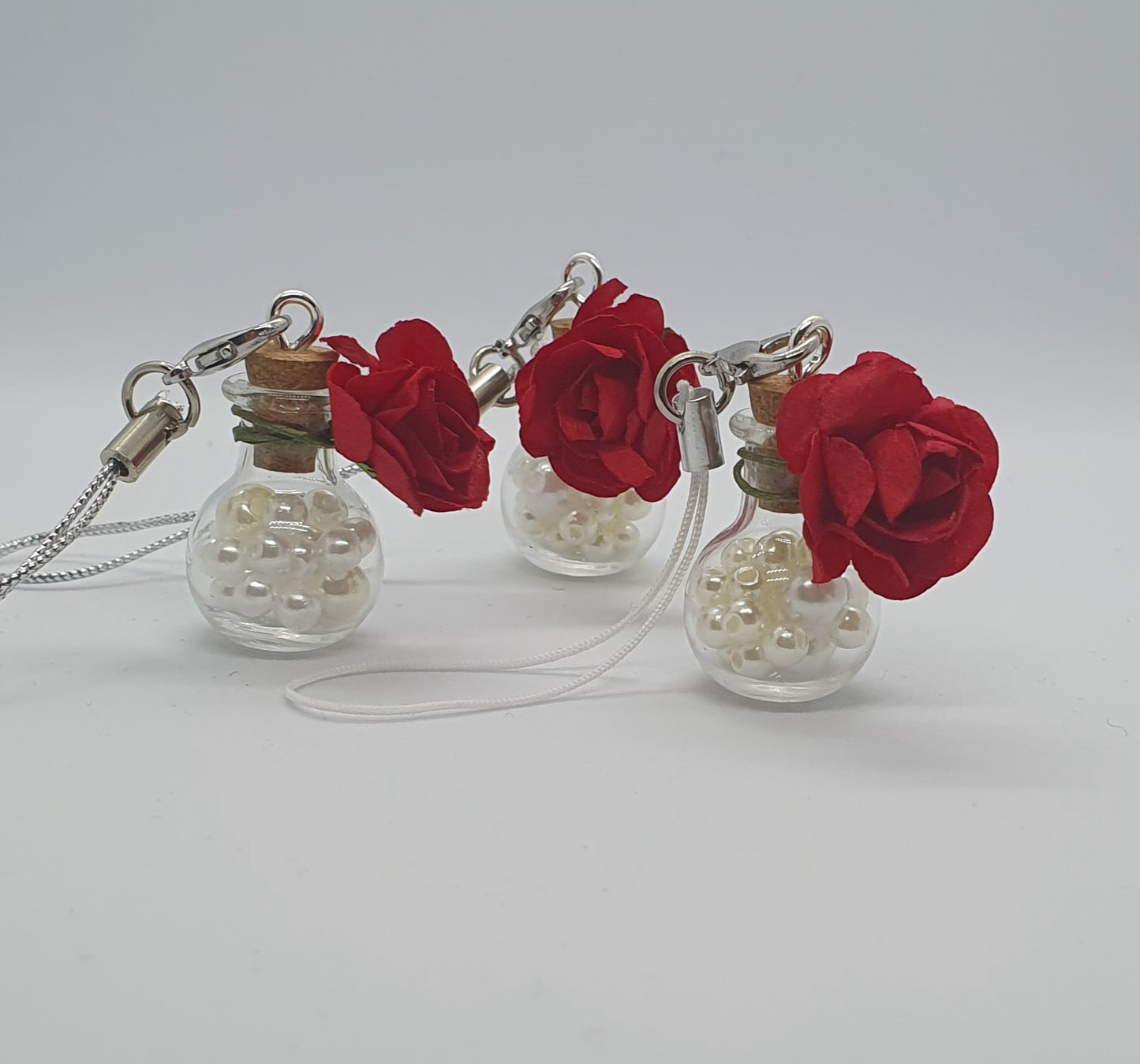 Glass potion bottle with faux pearl beads and rose keepsake charm