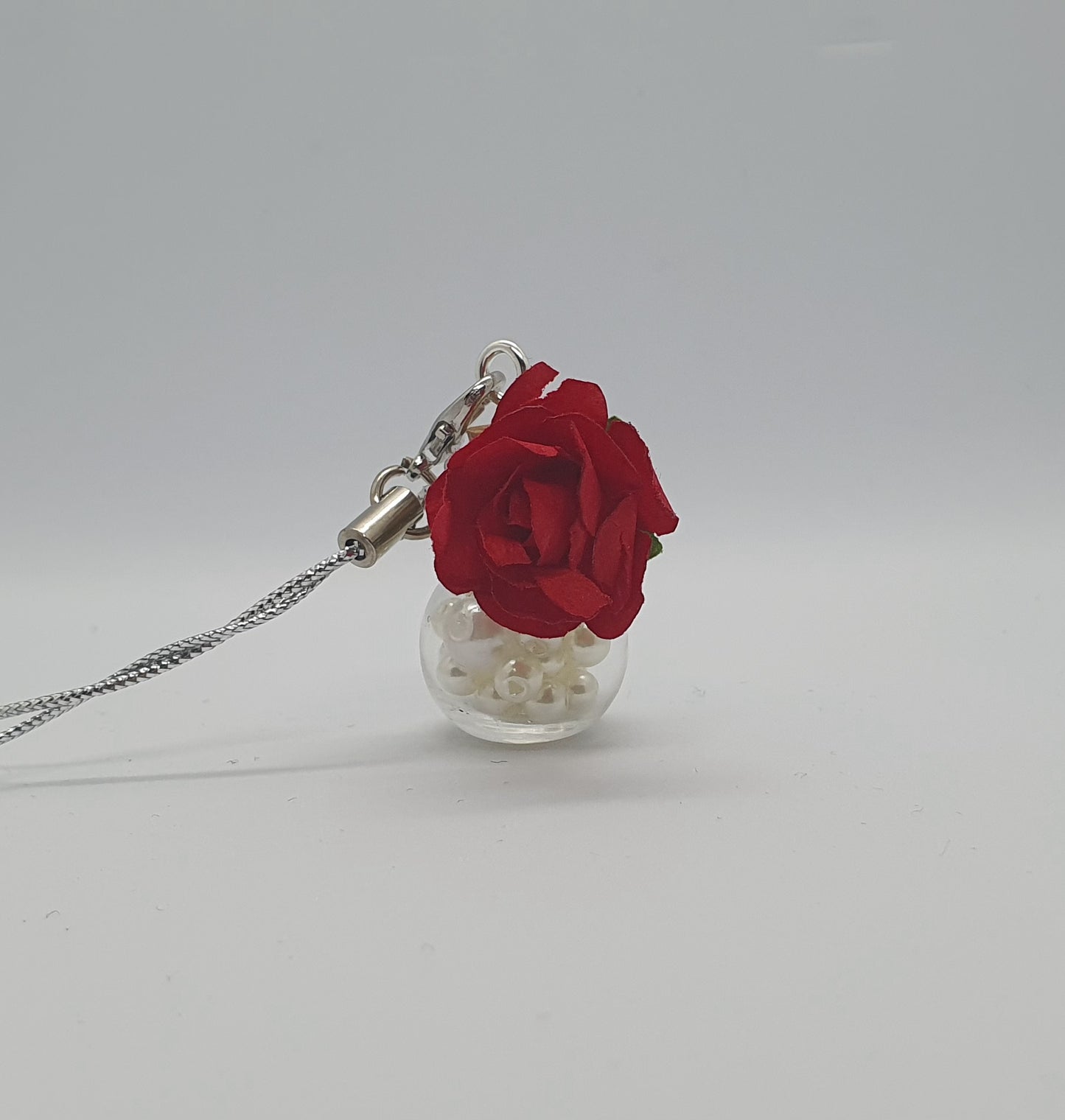 Glass potion bottle with faux pearl beads and rose keepsake charm