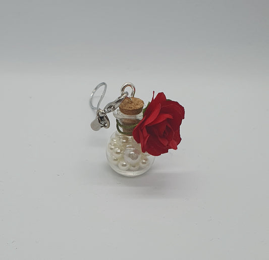 Glass potion bottle with faux pearl beads and rose keepsake charm