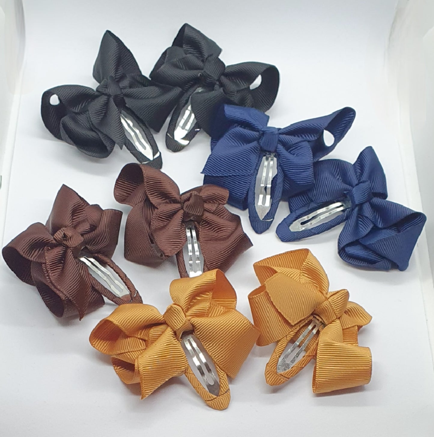 Four pairs of ribbon bow snap hair clip sets