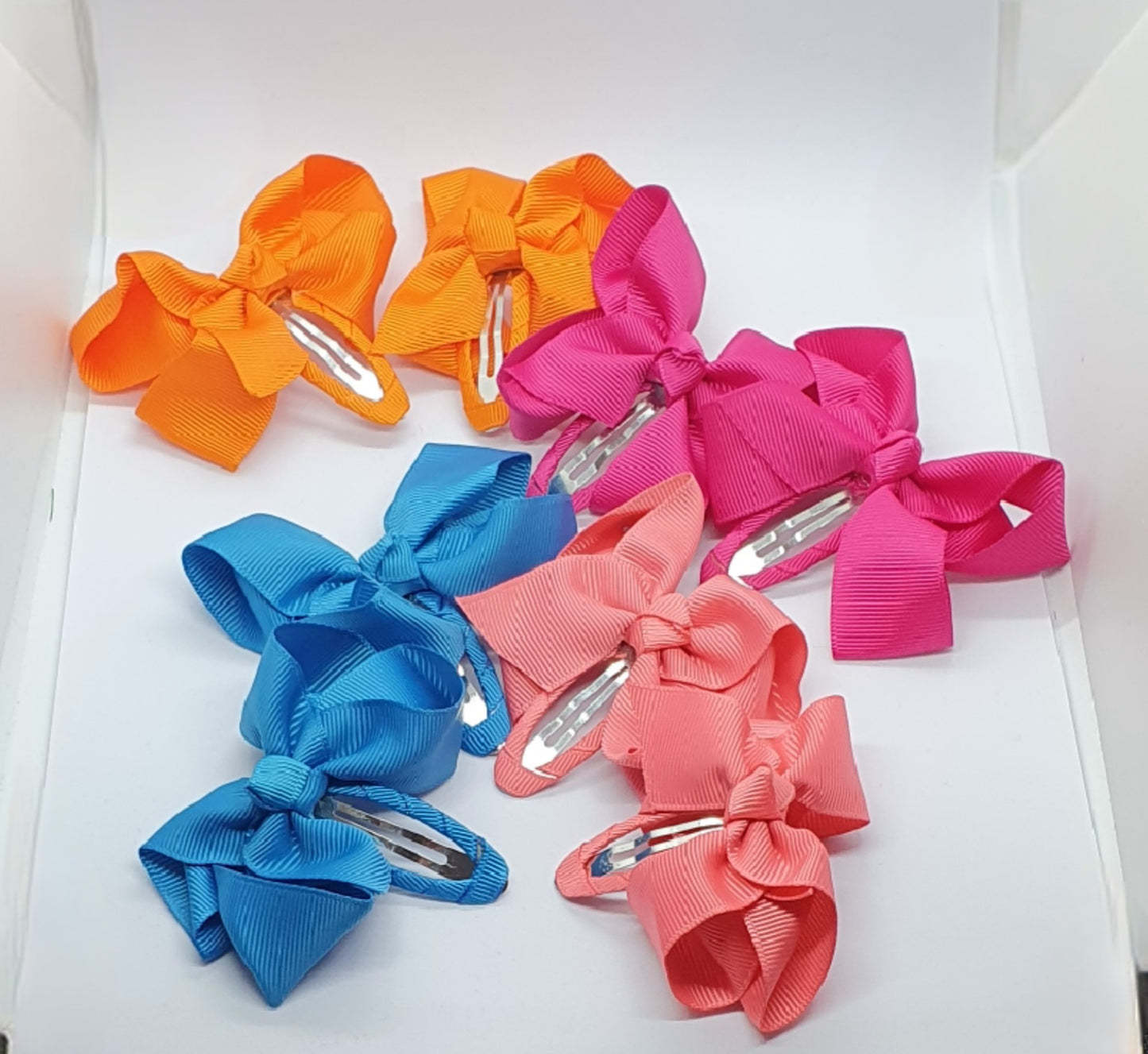 Four pairs of ribbon bow snap hair clip sets