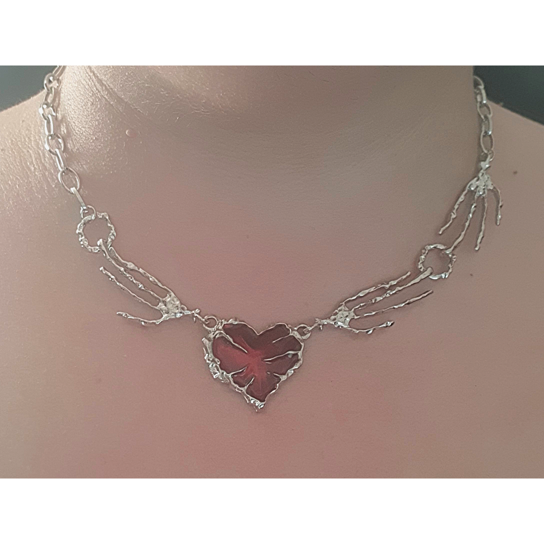 Blood red heart pendant with creepy bony hand and silver chain