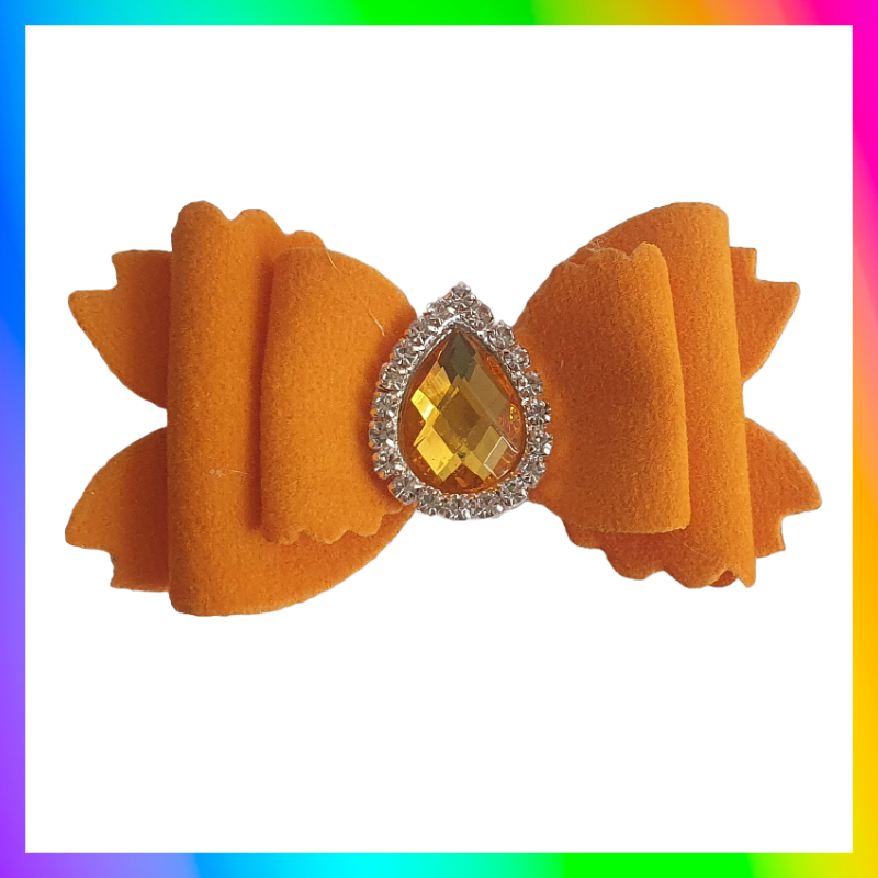 Soft velvet 3" double layered bow with droplet gem surrounded in little clear rhinestones on a crocodile clip comes in variety of colours