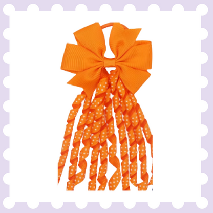 Pair of ribbon hair bow bobbles with polka dot curly ribbon tassels