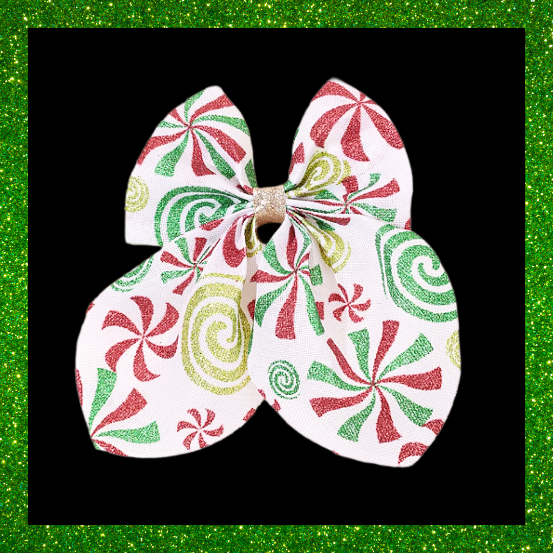 Large festive white hair bows with red green and gold candy swirl design