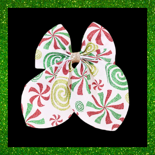Large festive white hair bows with red green and gold candy swirl design