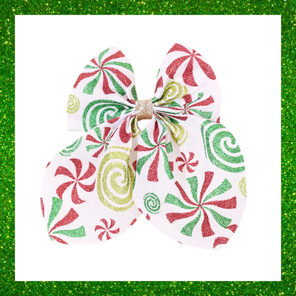 Large festive white hair bows with red green and gold candy swirl design