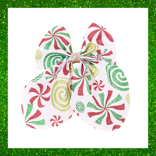 Large festive white hair bows with red green and gold candy swirl design