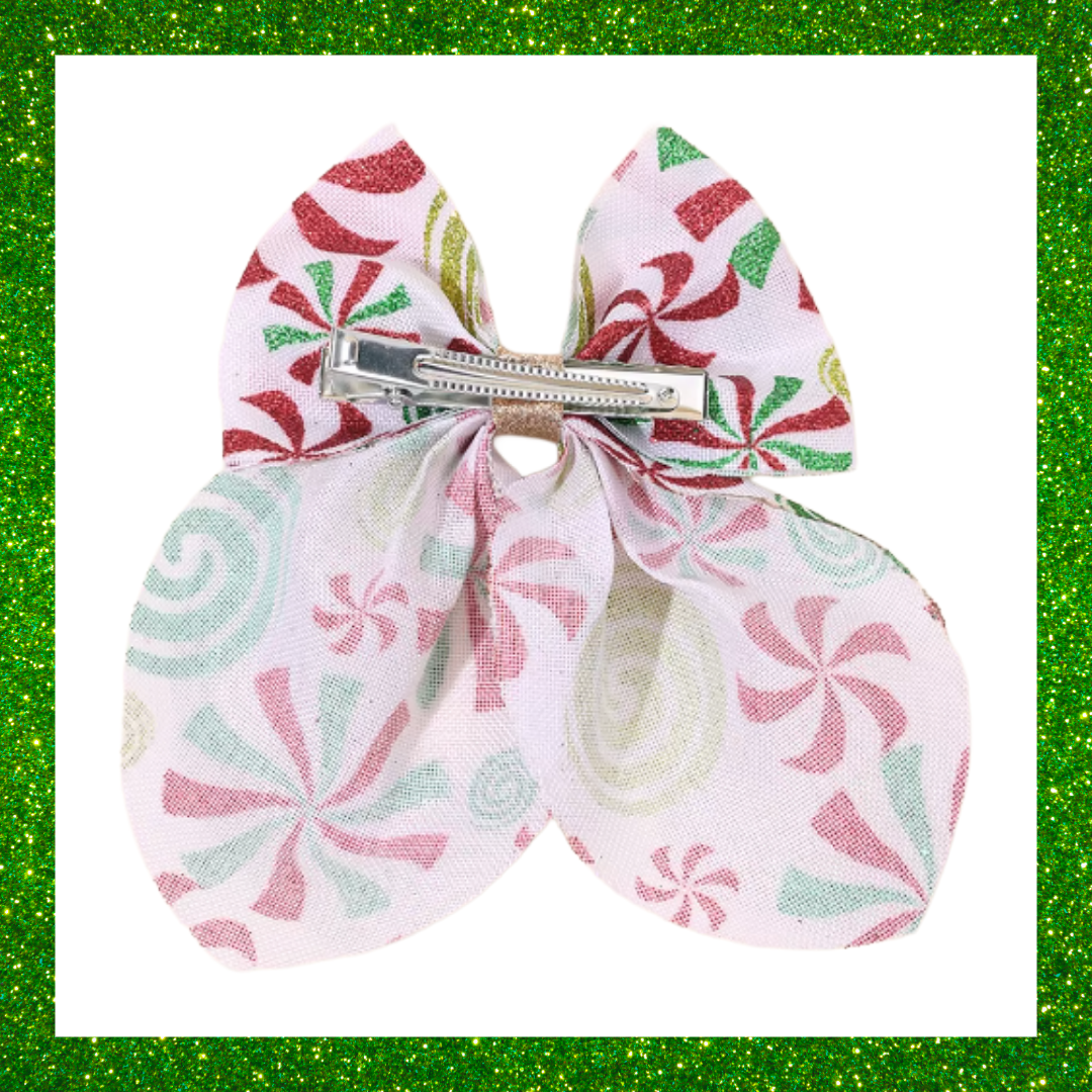 Large festive white hair bows with red green and gold candy swirl design
