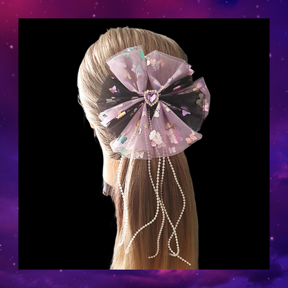 Purple and black large ribbon bow with dangly pearl beads and purple gem heart centre