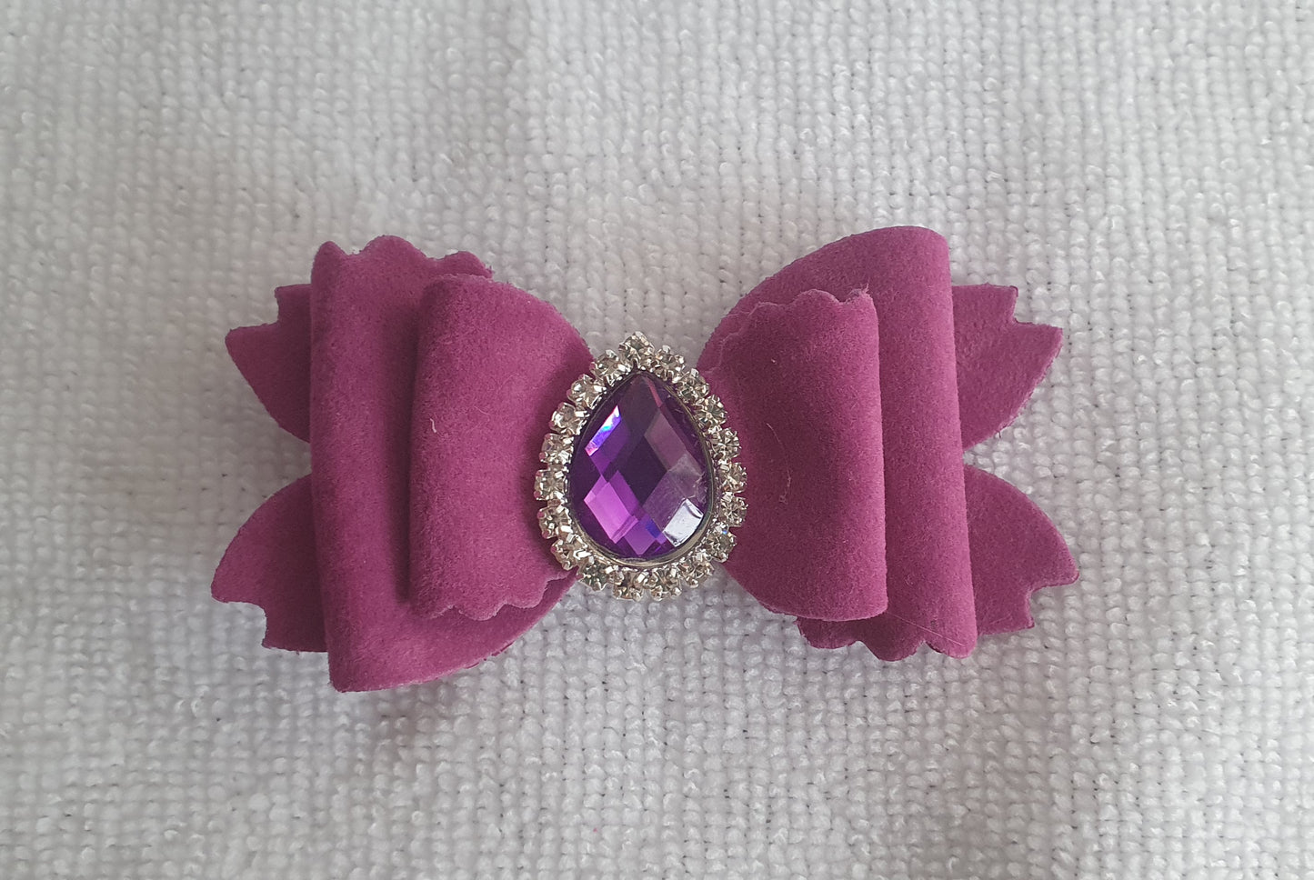 Soft velvet 3" double layered bow with droplet gem surrounded in little clear rhinestones on a crocodile clip comes in variety of colours