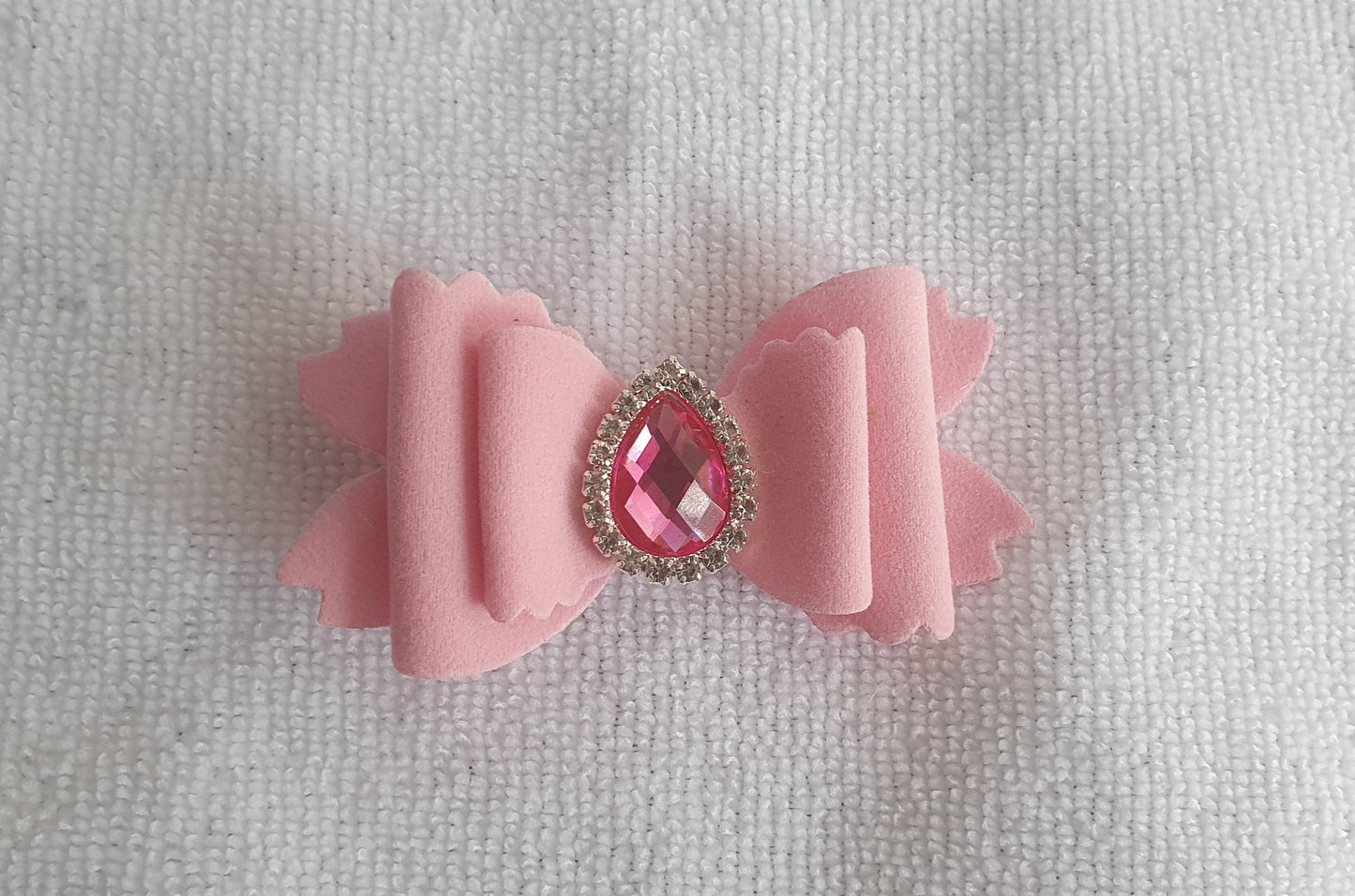 Soft velvet 3" double layered bow with droplet gem surrounded in little clear rhinestones on a crocodile clip comes in variety of colours