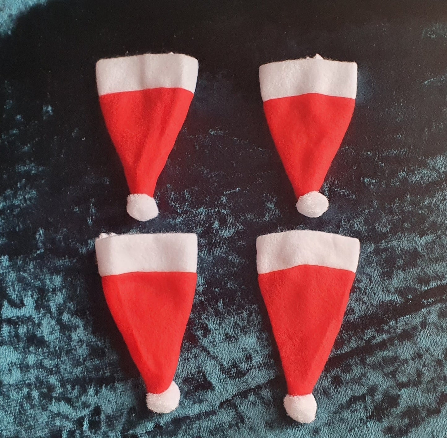 picture of four Santa hat cutlery covers - red and white in colour