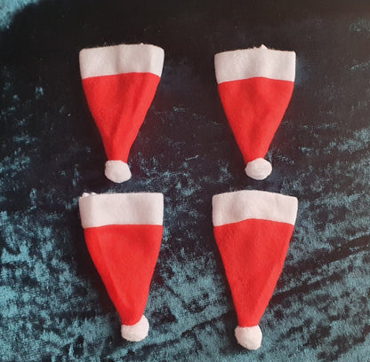 picture of four Santa hat cutlery covers - red and white in colour