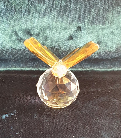 front of yellow butterfly crystal figure