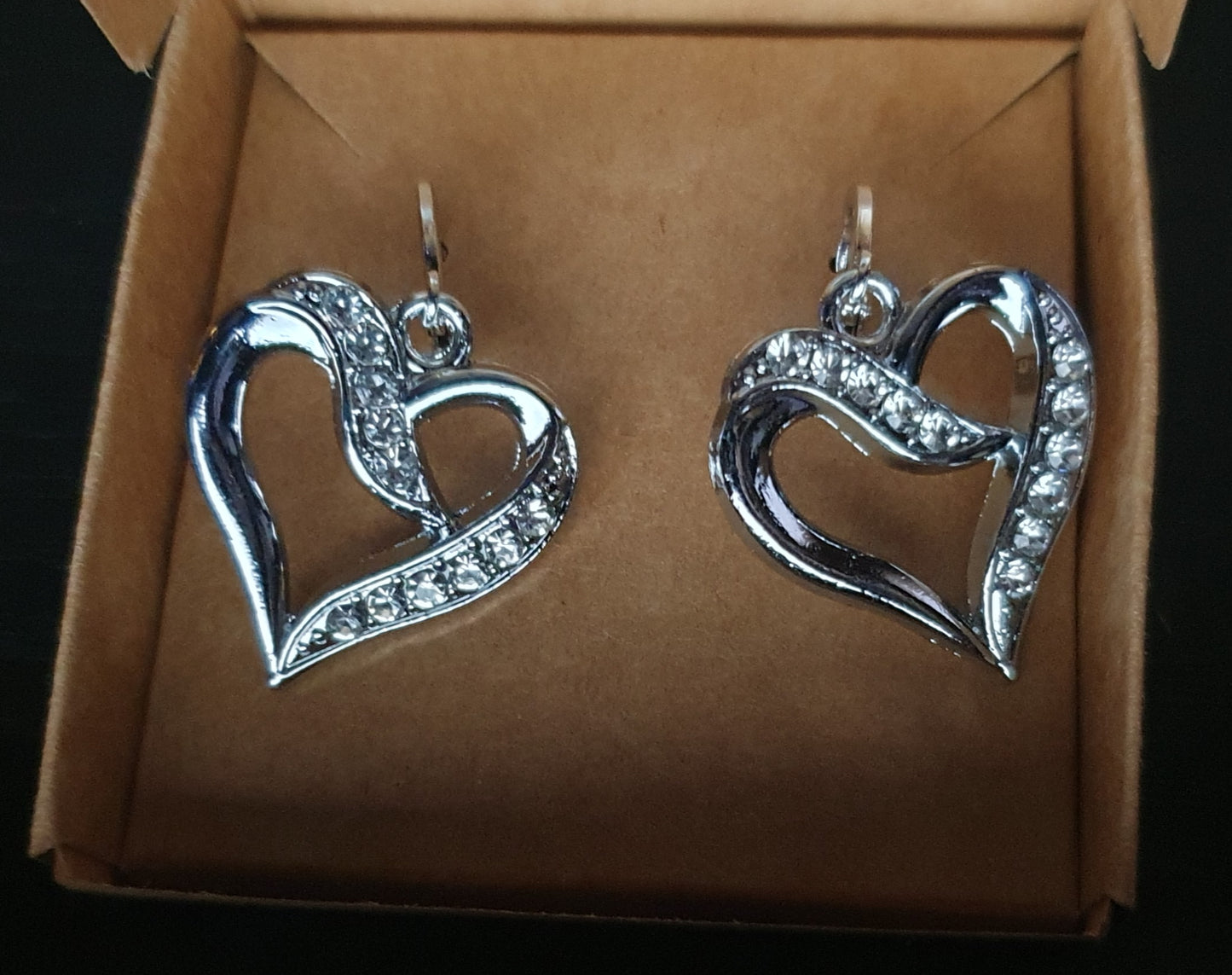 Heart shaped silver hoop earrings with cubic zirconia