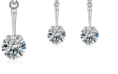 Silver dangly earrings and necklace with bow detail and cubic zirconia gift set