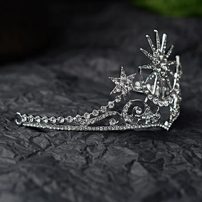 side view of The tiara is silver coloured with clear rhinestone crystals featuring a stunning celestial sun, moon and star theme