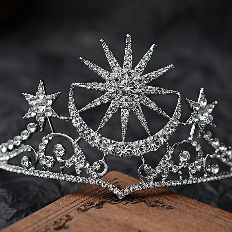 close up of The tiara is silver coloured with clear rhinestone crystals featuring a stunning celestial sun, moon and star theme